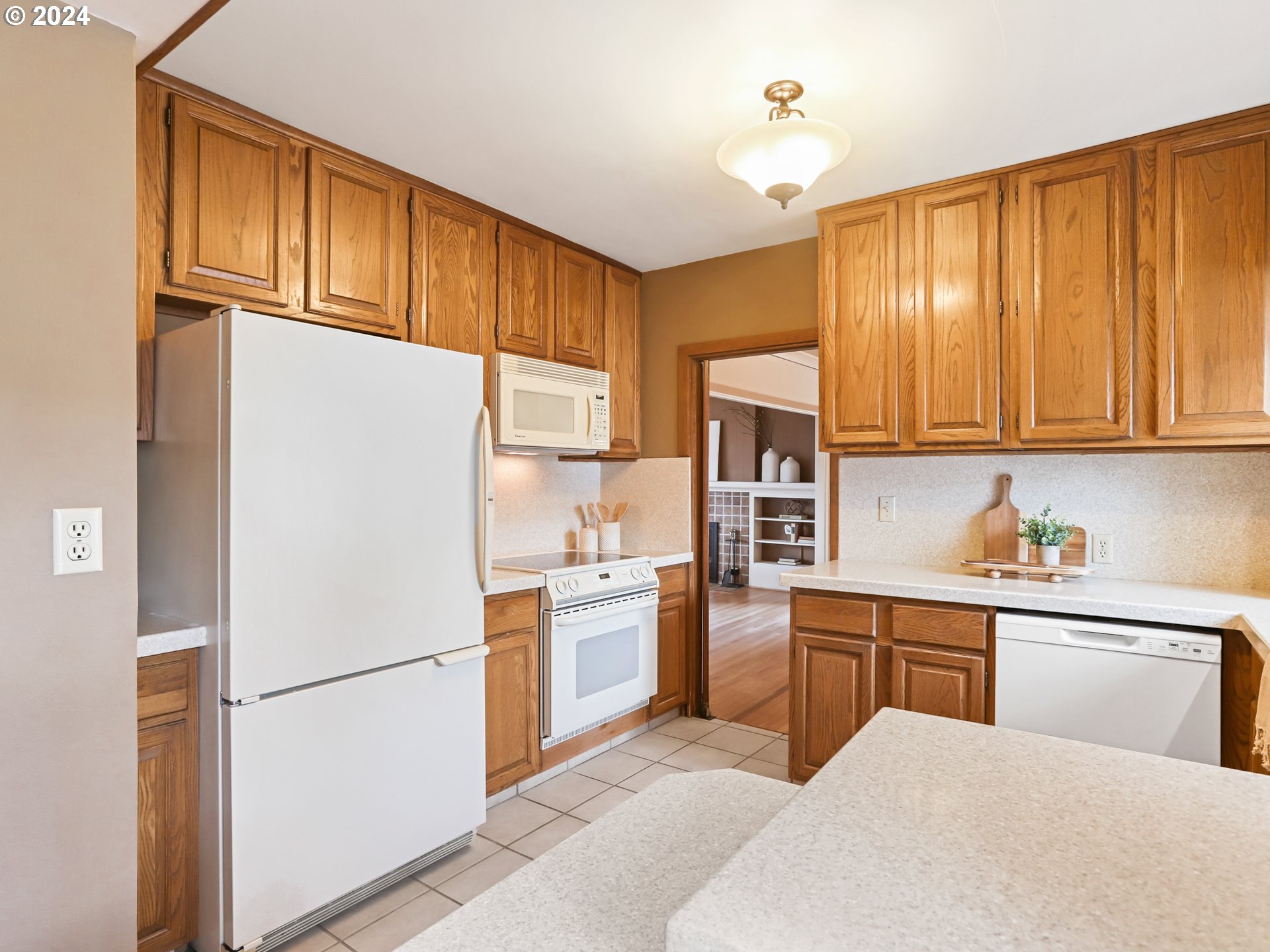 116 West 29th Street Vancouver, WA 98660 - Photo 15 of 35 a kitchen with a refrigerator a stove a sink cabinets and a dining table