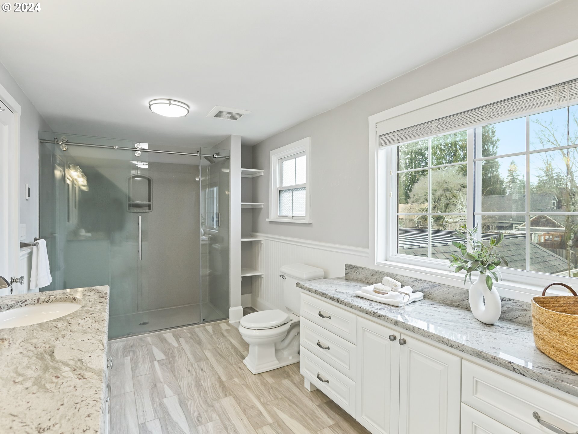 116 West 29th Street Vancouver, WA 98660 - Photo 20 of 35 a bathroom with a granite countertop sink toilet a large mirror a shower and a window