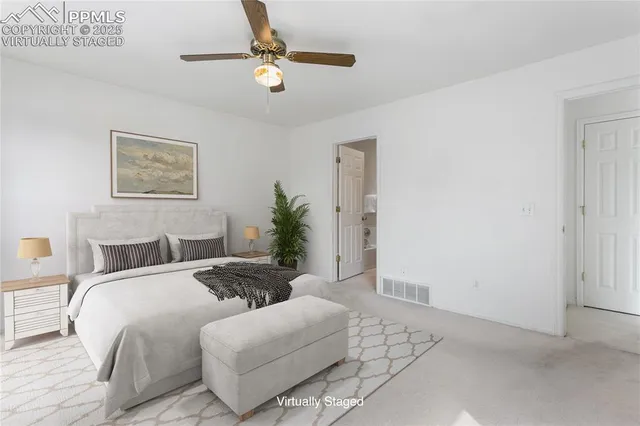 a spacious bedroom with a bed and ceiling fan