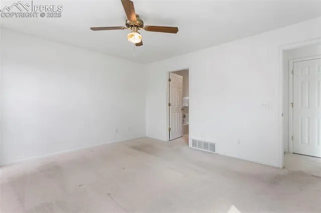 an empty room with white walls