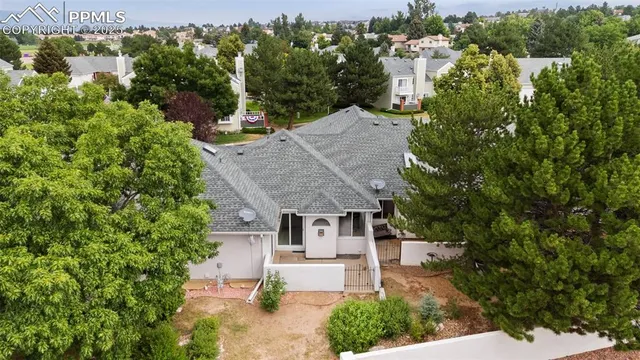 an aerial view of a house with a garden and a yard