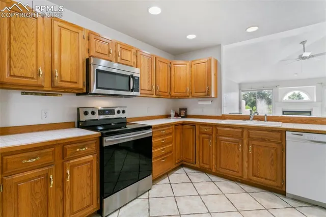 a kitchen with stainless steel appliances granite countertop a stove sink microwave and cabinets
