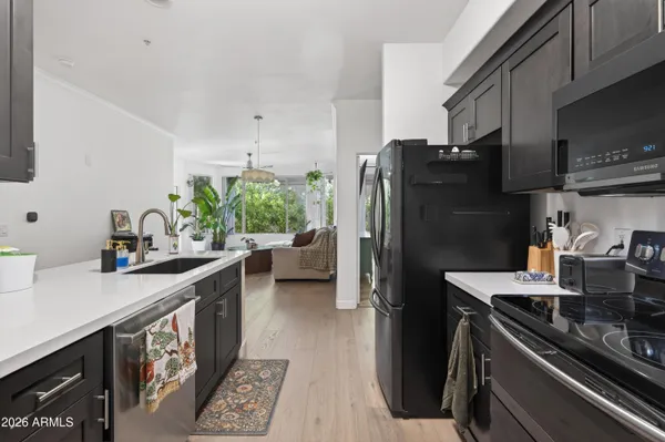 a kitchen with a refrigerator and a sink
