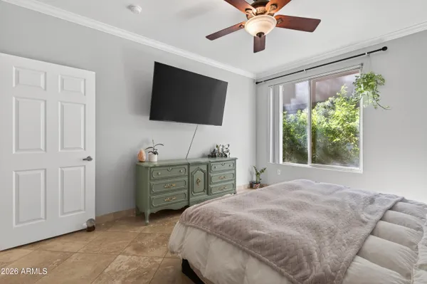 a bedroom with a bed and a flat screen tv