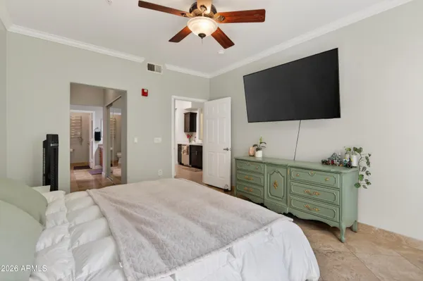 a bedroom with a bed and a flat screen tv