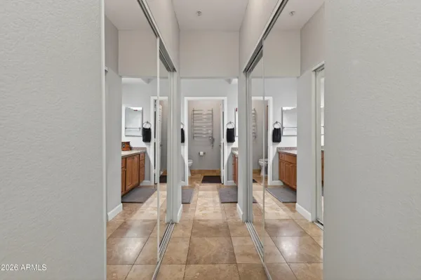 a bathroom with a glass door shower a sink and a mirror