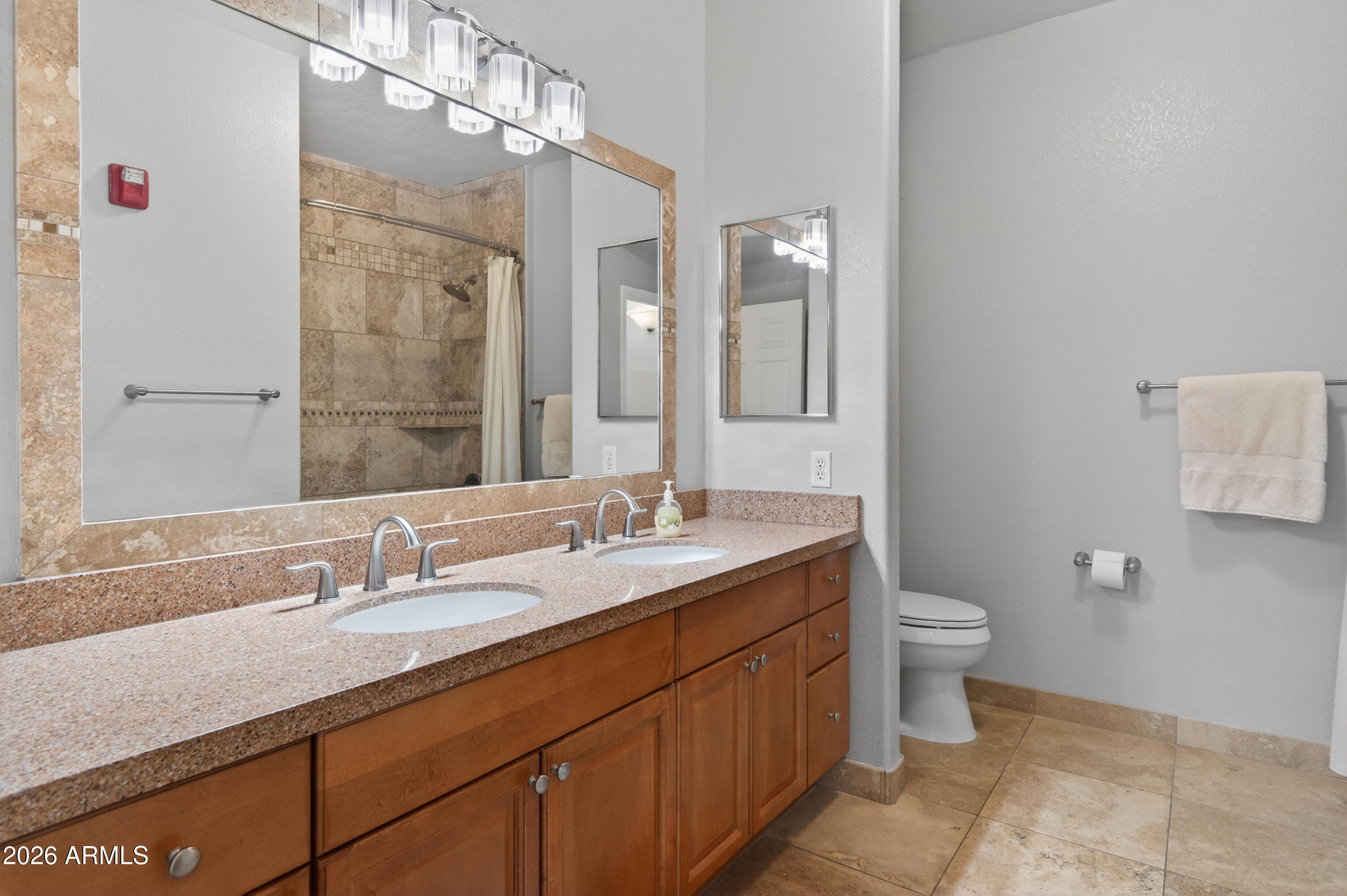 435 West Rio Salado Parkway, Unit 112 Tempe, AZ 85281 - Photo 26 of 38 a bathroom with a granite countertop sink a toilet and a mirror