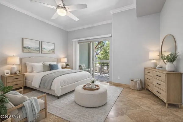 a spacious bedroom with a bed and a chandelier