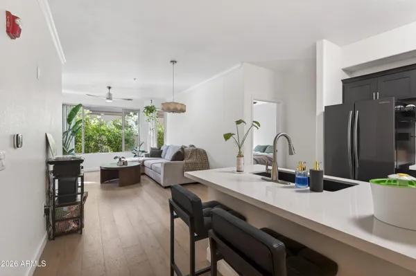 a kitchen with a table chairs and wooden floor