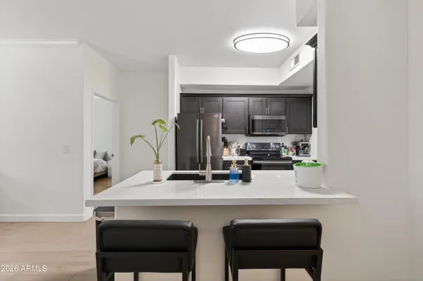 a kitchen with a sink cabinets and stainless steel appliances