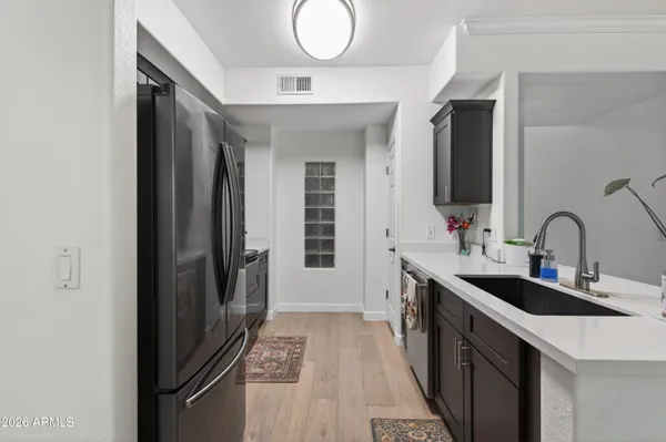a kitchen with granite countertop a sink stove and refrigerator