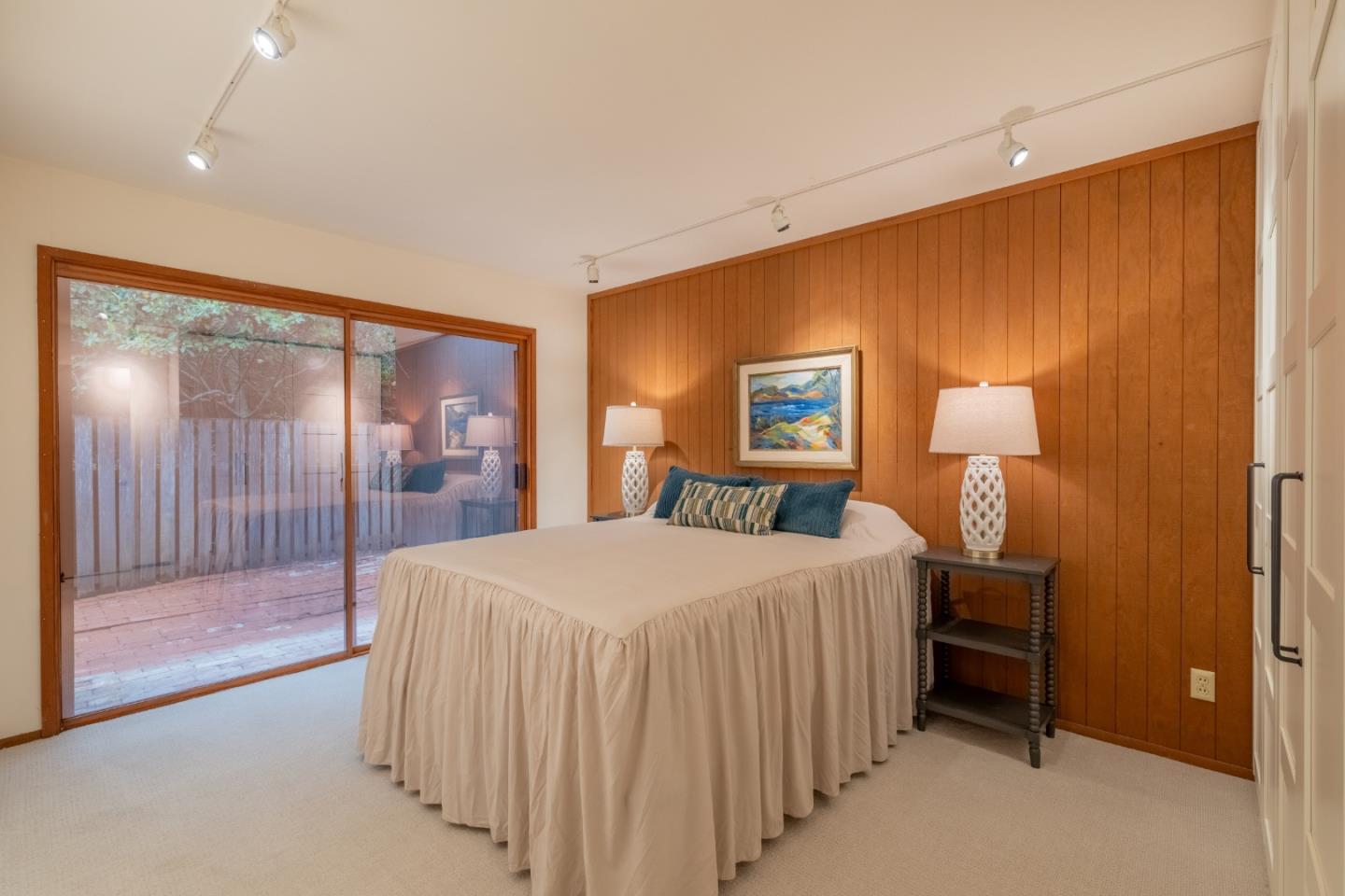 46 Middle Canyon Road Carmel Valley, CA 93924 - Photo 29 of 74 a bedroom with a bed and a lamp