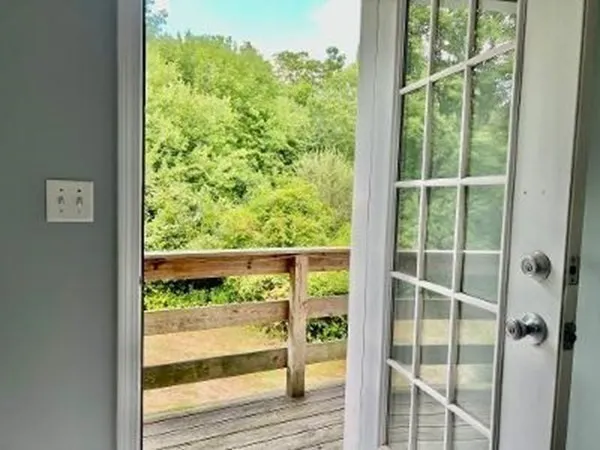 a view of a room with wooden floor and windows
