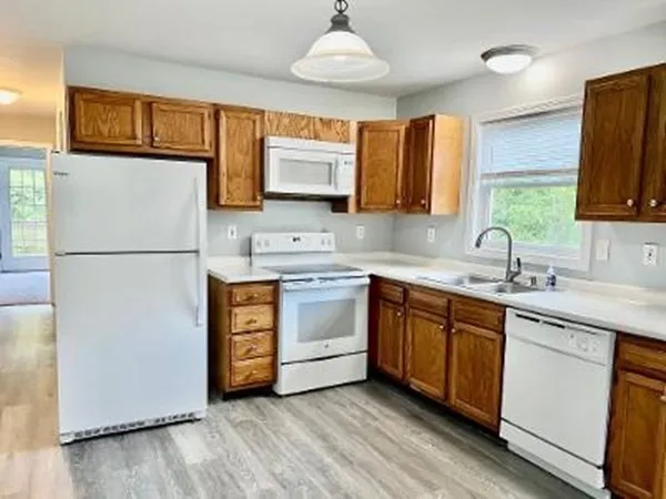 a kitchen with stainless steel appliances a refrigerator sink and microwave