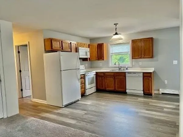 a kitchen with stainless steel appliances granite countertop a refrigerator a stove and a sink
