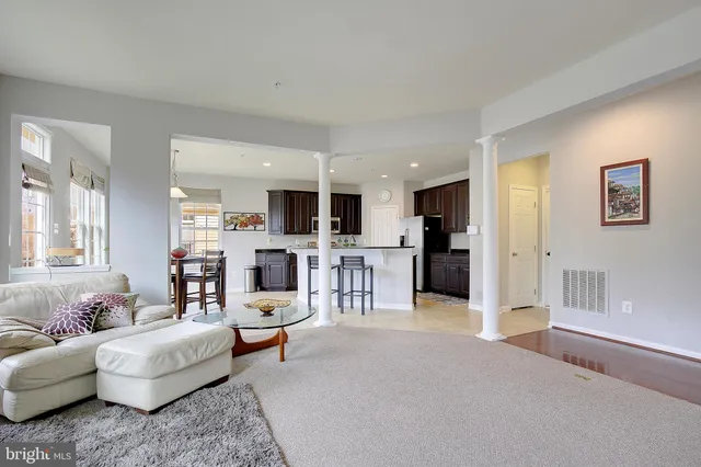 a kitchen with a refrigerator and a stove top oven