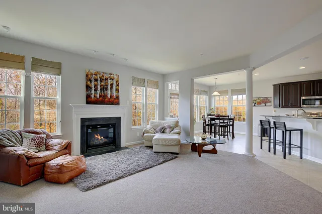 a dining room with furniture window and wooden floor
