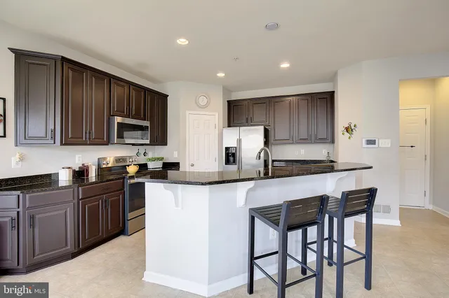 a bathroom with a sink a toilet a mirror a bathtub and shower