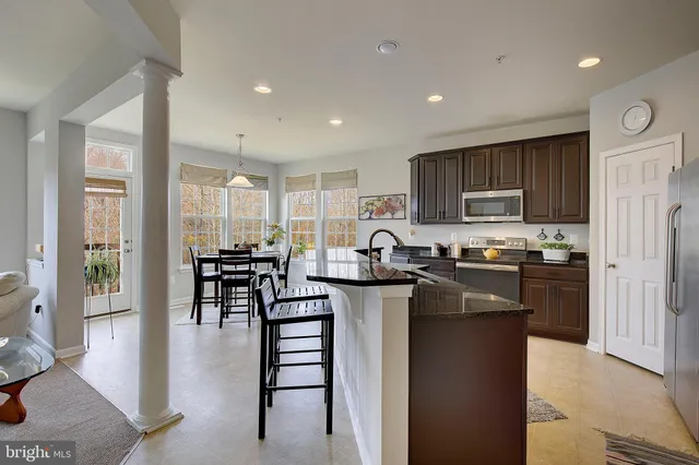 a view of a livingroom with furniture and staircase