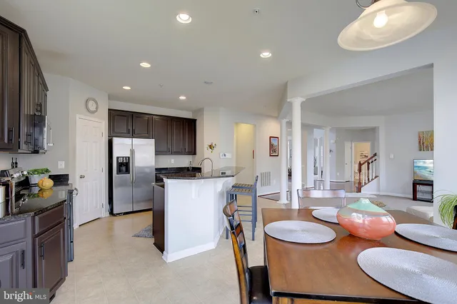 a living room with furniture a clock and a window