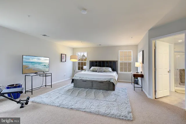 a bedroom with a bed and a painting on the wall