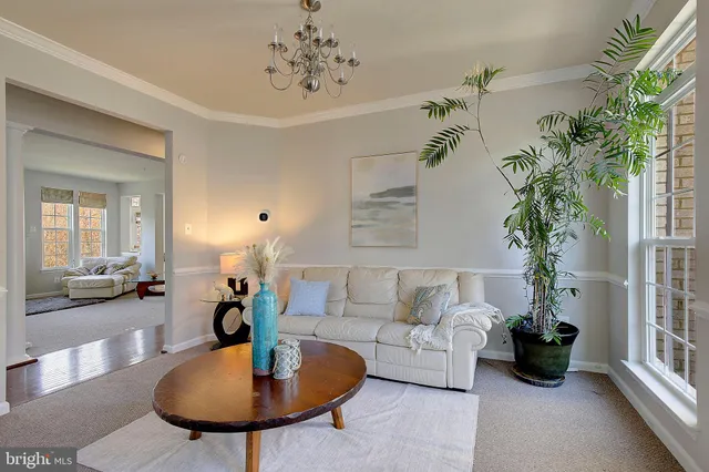 a living room with furniture and a chandelier