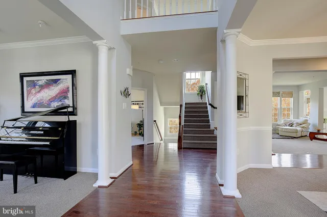 a living room with furniture and a view of kitchen