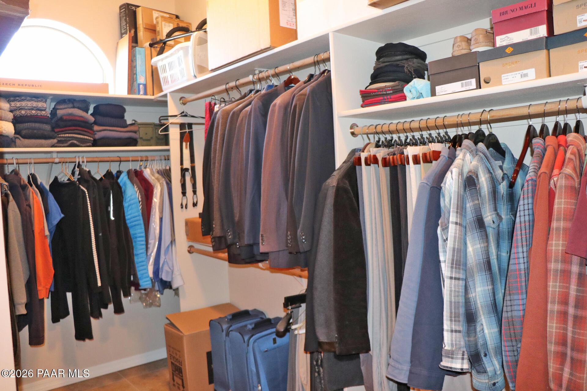 7051 Dillon Wash Road Prescott, AZ 86305 - Photo 16 of 31 a view of walk in closet with clothes and shoes