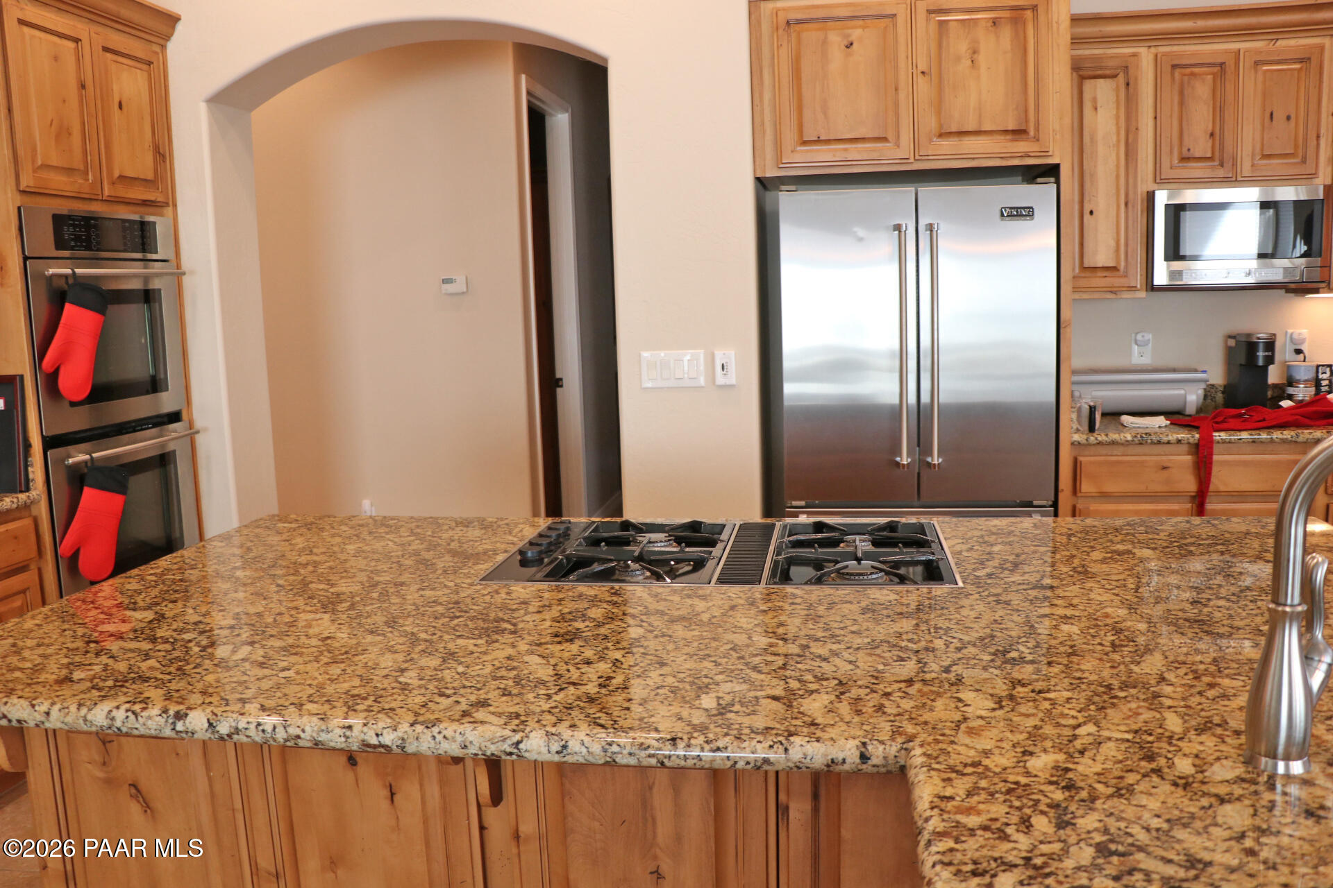 7051 Dillon Wash Road Prescott, AZ 86305 - Photo 22 of 31 a kitchen with granite countertop a refrigerator stove and cabinets