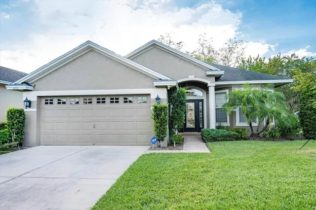 a view of a house with yard and a garden