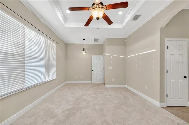 en empty room with window and ceiling fan