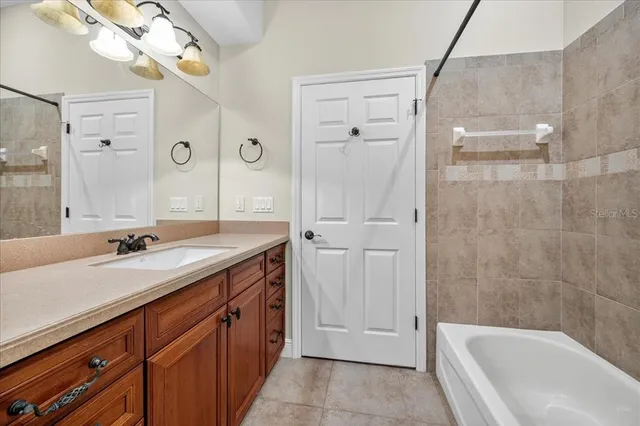 a bathroom with a tub a sink and a mirror