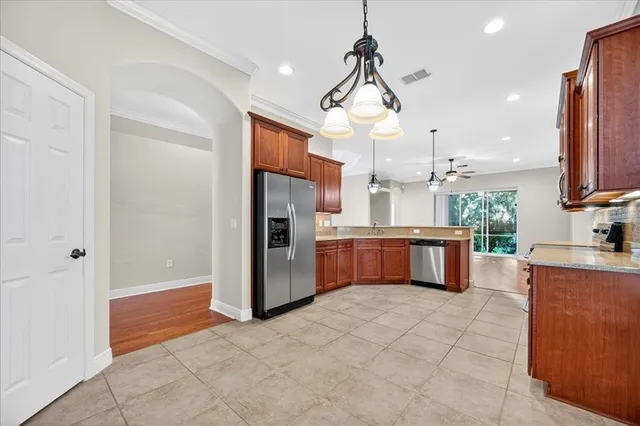 a kitchen with stainless steel appliances granite countertop a refrigerator a oven a sink and dishwasher