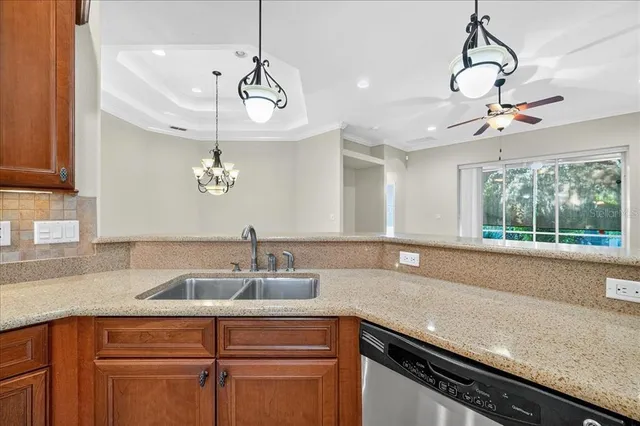a kitchen with a sink and chandelier