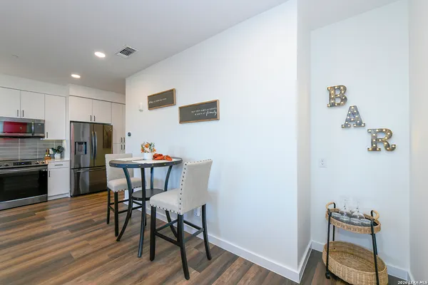 a view of a dining room with furniture and wooden floor