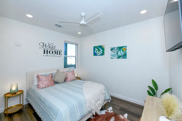 a bedroom with a bed and a potted plant