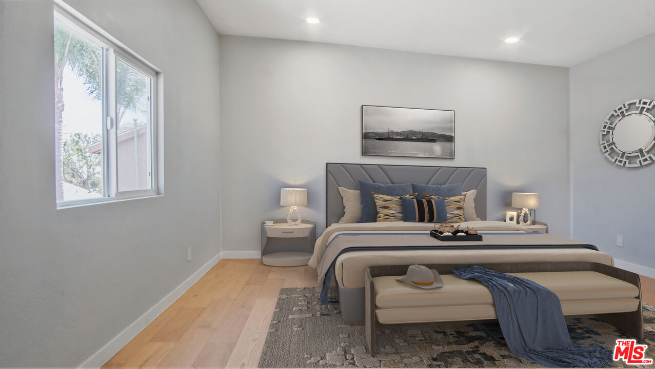 1610 East Carson Street, Unit 3 Long Beach, CA 90807 - Photo 11 of 21 a bedroom with a bed and lamp