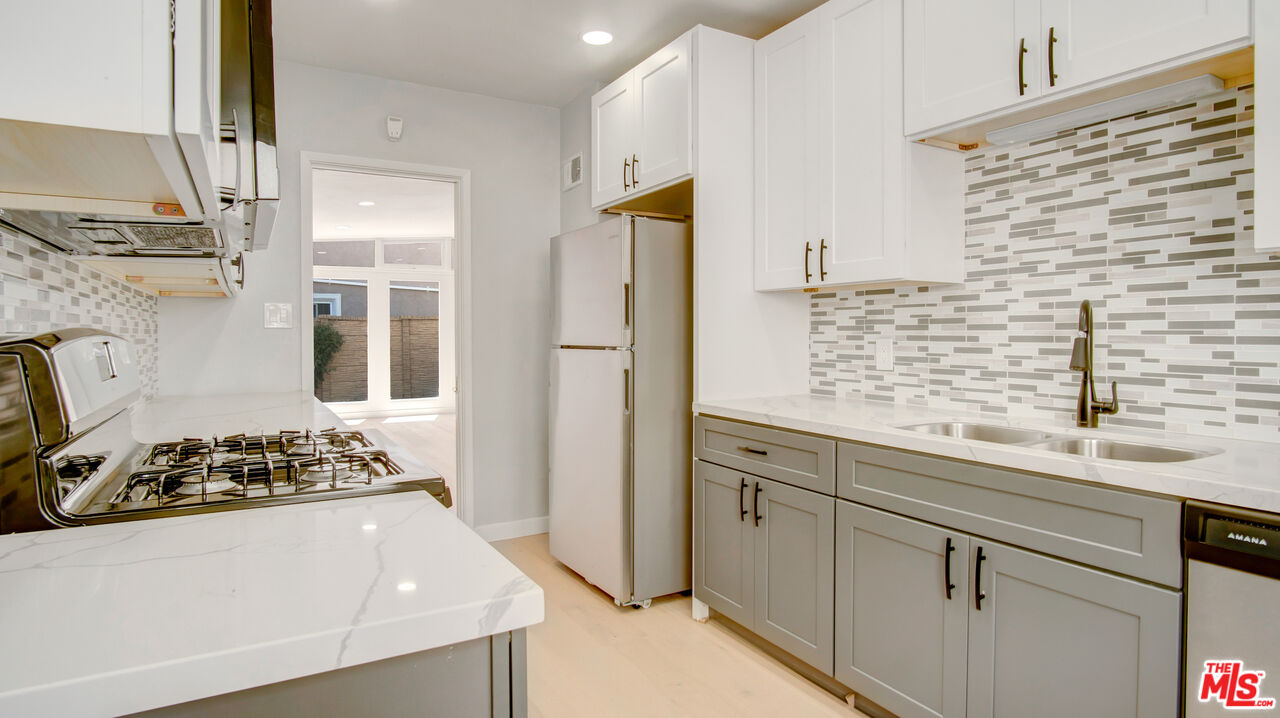 1610 East Carson Street, Unit 3 Long Beach, CA 90807 - Photo 5 of 21 a kitchen with stainless steel appliances granite countertop a refrigerator and a sink