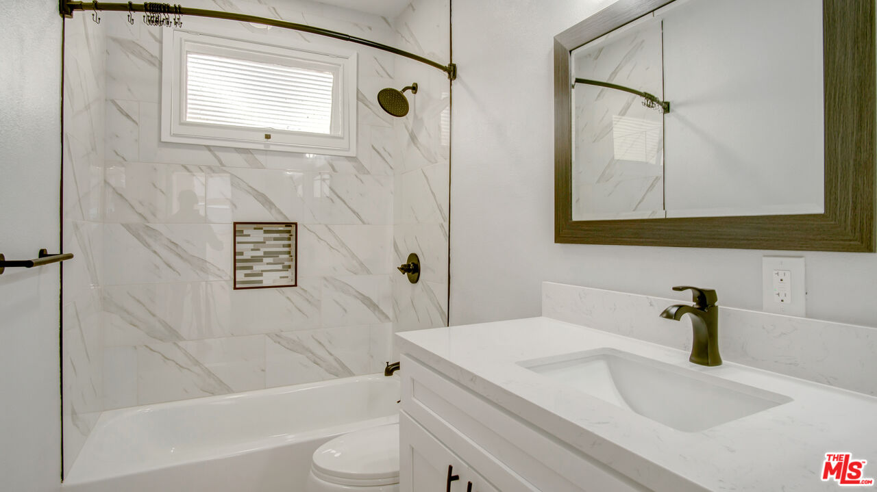1610 East Carson Street, Unit 3 Long Beach, CA 90807 - Photo 7 of 21 a bathroom with a sink a toilet and shower
