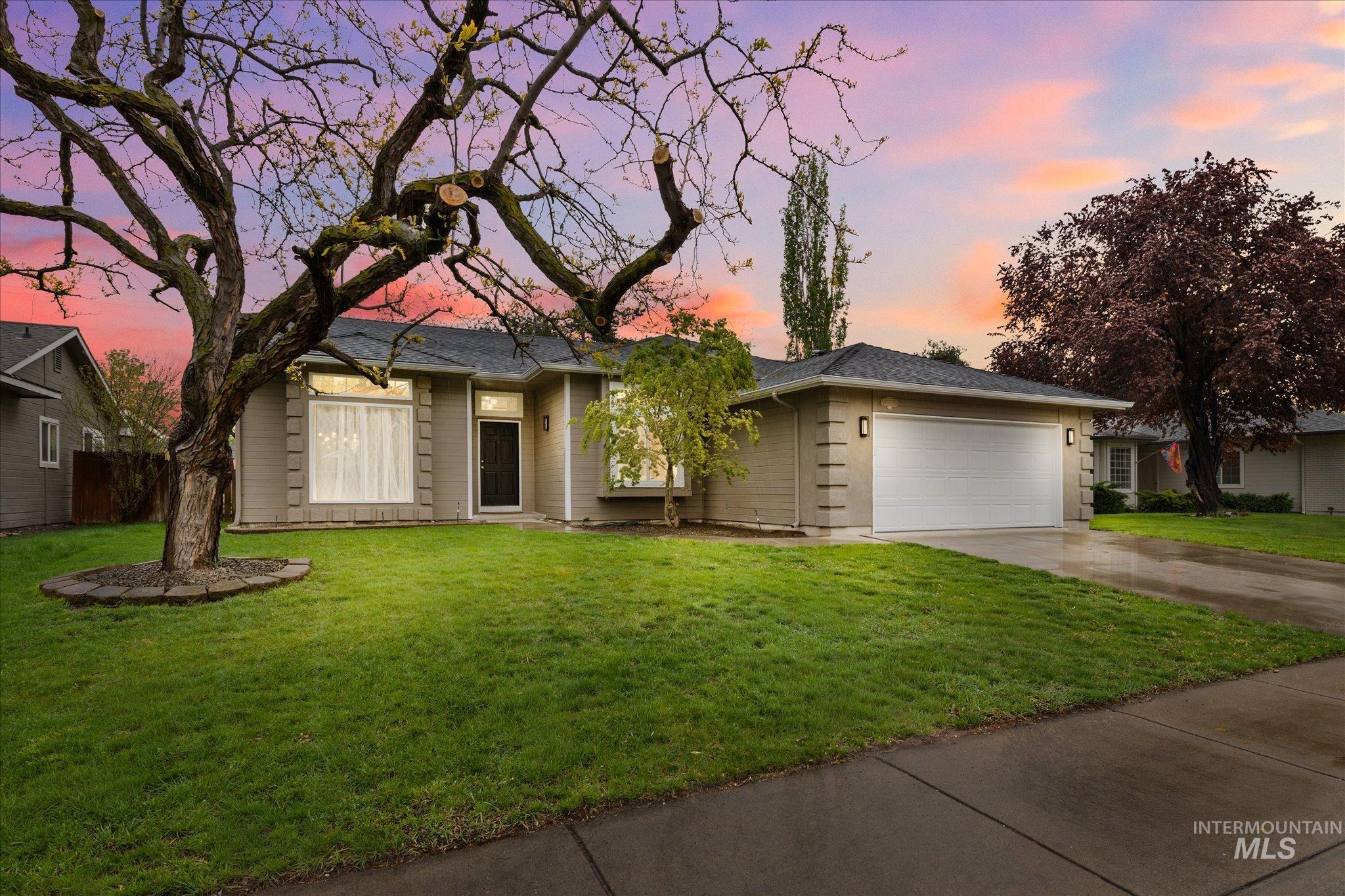 2250 North Amethyst Avenue Meridian, ID 83646 - Photo 1 of 50 Ranch-style house with a lawn, concrete driveway, and an attached garage
