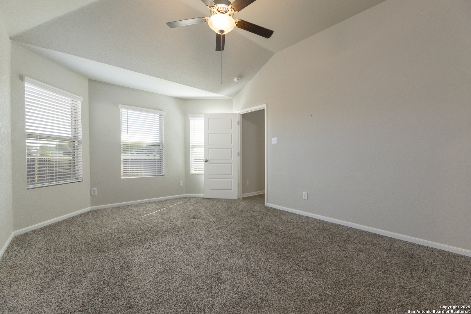 765 Stonemanor Bay Seguin, TX 78155 - Photo 16 of 29 an empty room with windows and fan