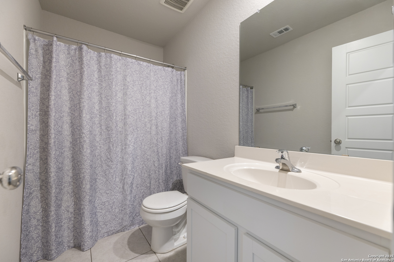765 Stonemanor Bay Seguin, TX 78155 - Photo 23 of 29 a bathroom with a sink a toilet and shower curtain