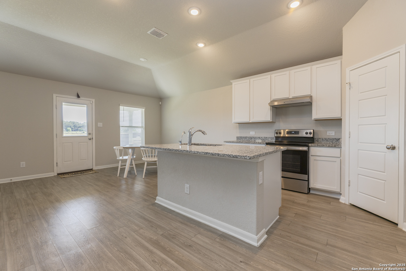 765 Stonemanor Bay Seguin, TX 78155 - Photo 4 of 29 a kitchen with a white cabinets and chairs