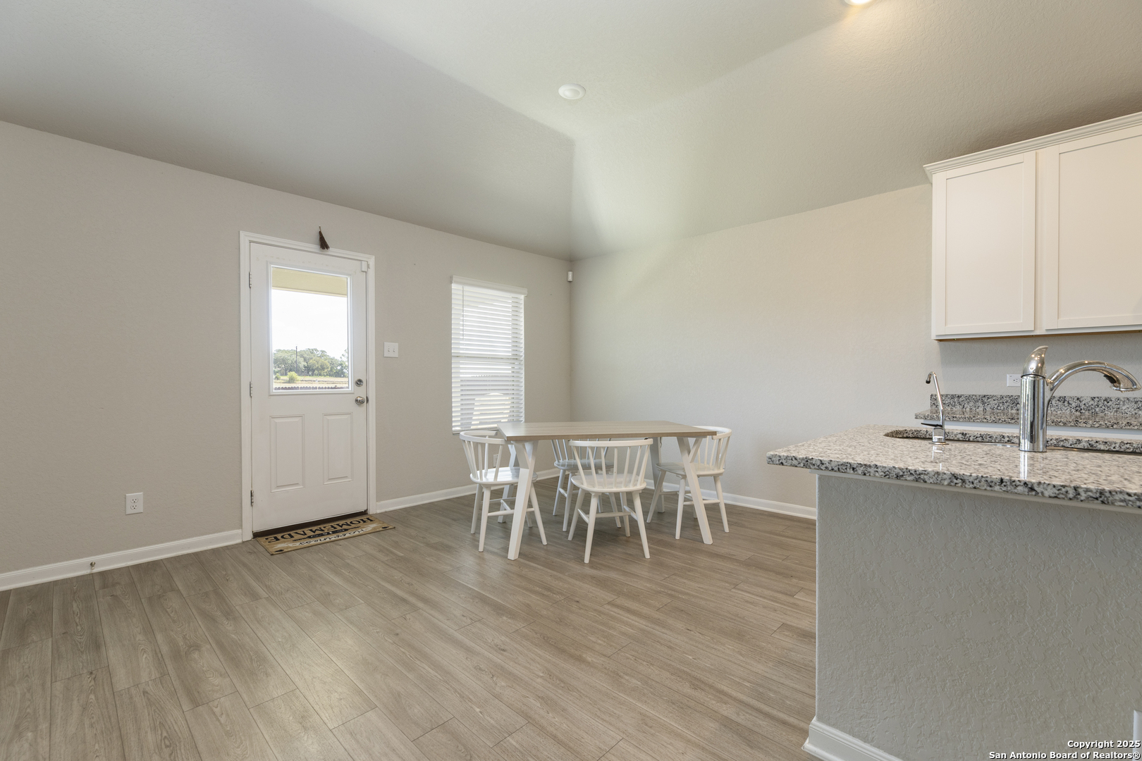 765 Stonemanor Bay Seguin, TX 78155 - Photo 7 of 29 a dining room with furniture and wooden floor