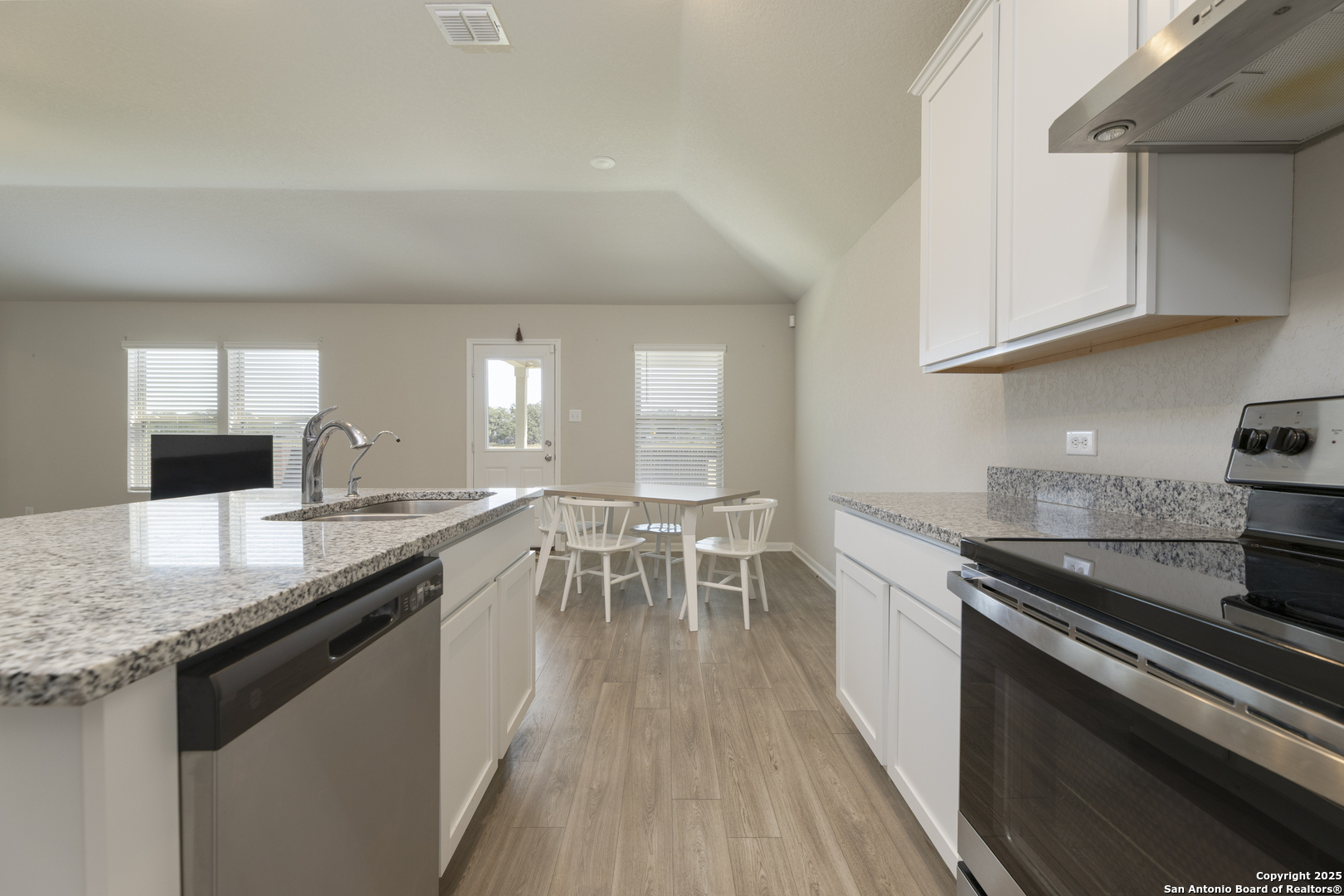 765 Stonemanor Bay Seguin, TX 78155 - Photo 10 of 29 a kitchen with granite countertop a sink stove and cabinets