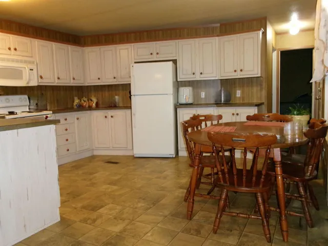 a kitchen with stainless steel appliances a stove a refrigerator sink and cabinets