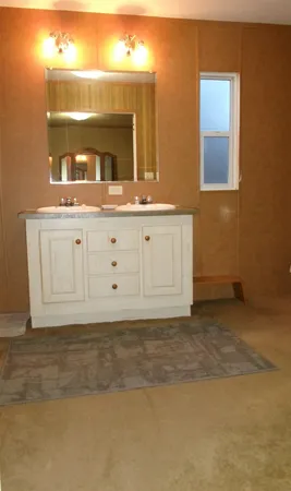 a view of a bathroom with mirror and sink
