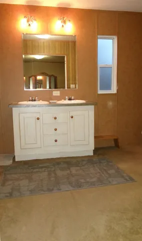 a view of a bathroom with mirror and sink