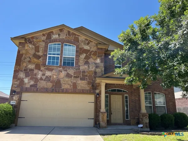 a front view of a house with yard