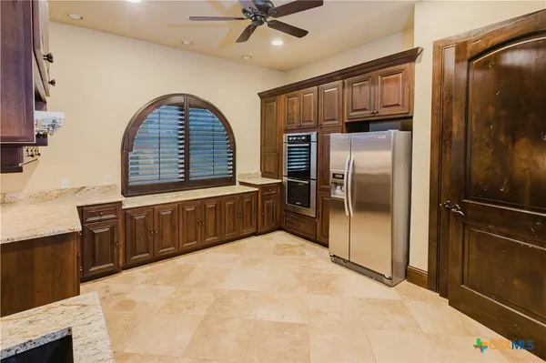 a kitchen with stainless steel appliances a refrigerator and a counter top space
